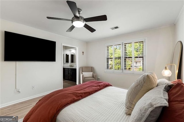 1420 Defoors Dr NW, Atlanta, GA 30318 - bedroom with a ceiling fan, wood finished floors, ensuite bathroom, baseboards, and visible vents
