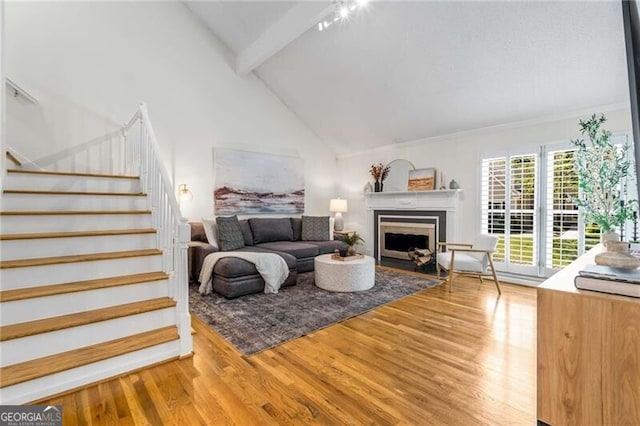 1420 Defoors Dr NW, Atlanta, GA 30318 - living room with high vaulted ceiling, stairs, wood finished floors, a fireplace, and beam ceiling