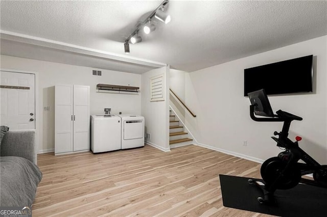 1420 Defoors Dr NW, Atlanta, GA 30318 - workout area featuring a textured ceiling, separate washer and dryer, light wood-style flooring, baseboards, and visible vents