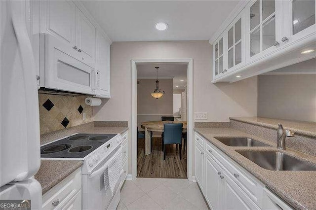 110 Barrington Hills Dr Unit 110, Atlanta, GA 30350 - kitchen featuring tasteful backsplash, a sink, white appliances, glass insert cabinets, and white cabinetry