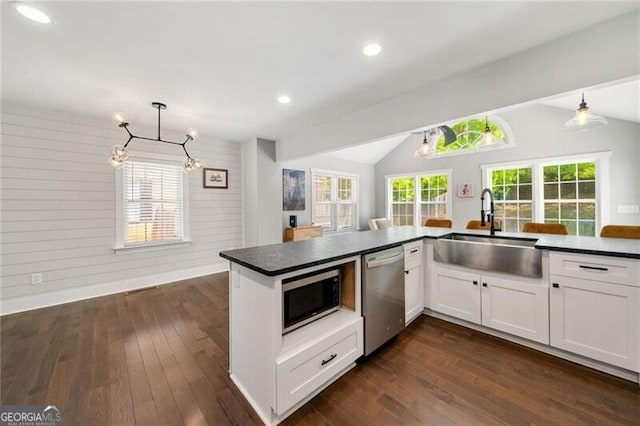 1535 Deerwood Dr, Decatur, GA 30030 - kitchen featuring lofted ceiling, stainless steel appliances, an inviting chandelier, dark countertops, and a sink