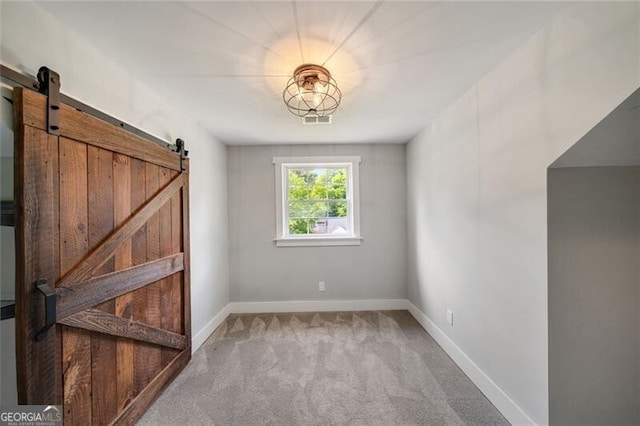1535 Deerwood Dr, Decatur, GA 30030 - carpeted spare room featuring a barn door and baseboards