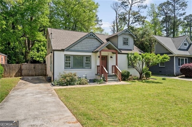 1535 Deerwood Dr, Decatur, GA 30030 - view of front of house with fence, a shingled roof, driveway, and a front yard