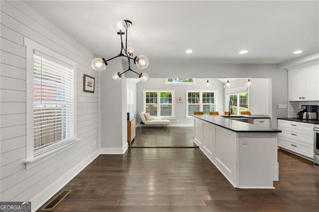1535 Deerwood Dr, Decatur, GA 30030 - kitchen featuring dark countertops, visible vents, a wealth of natural light, and dark wood-style floors