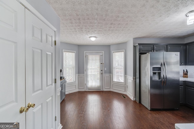 3095 Willow Park Dr, Dacula, GA 30019 - kitchen featuring a wealth of natural light, wainscoting, dark wood-style flooring, and stainless steel fridge with ice dispenser