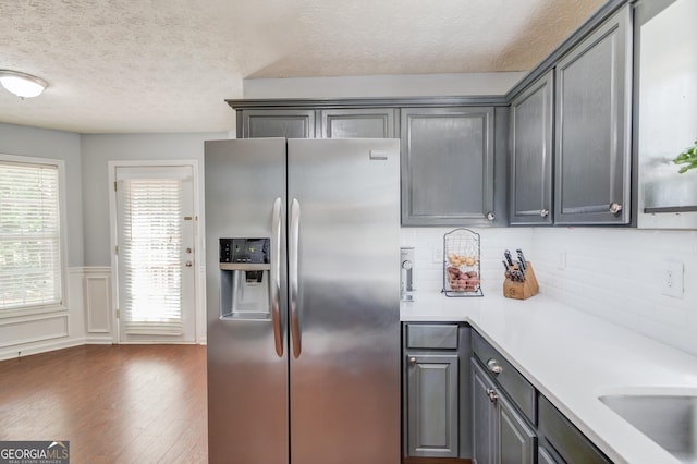 3095 Willow Park Dr, Dacula, GA 30019 - kitchen featuring a textured ceiling, dark wood-style flooring, gray cabinetry, stainless steel refrigerator with ice dispenser, and light countertops