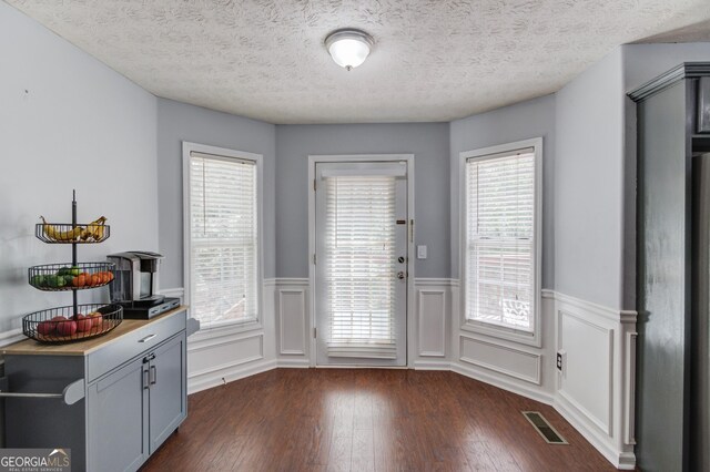 3095 Willow Park Dr, Dacula, GA 30019 - entryway with dark wood-type flooring, plenty of natural light, visible vents, and wainscoting