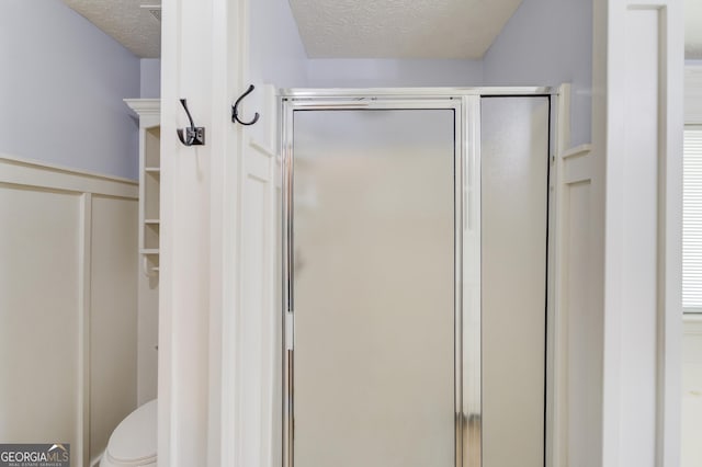 3095 Willow Park Dr, Dacula, GA 30019 - full bath featuring a textured ceiling, a shower stall, and toilet