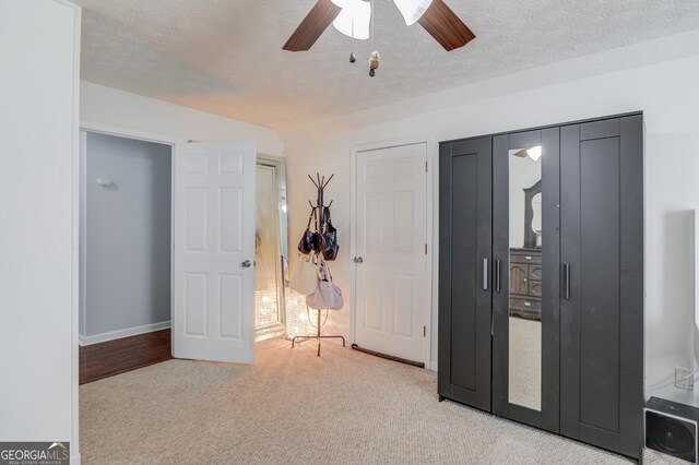 3095 Willow Park Dr, Dacula, GA 30019 - carpeted bedroom with a textured ceiling, baseboards, and ceiling fan
