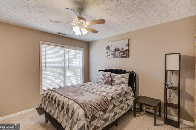 3095 Willow Park Dr, Dacula, GA 30019 - carpeted bedroom with a textured ceiling, visible vents, baseboards, and ceiling fan