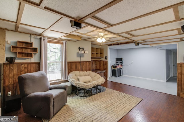 3095 Willow Park Dr, Dacula, GA 30019 - living area with a wainscoted wall, wood walls, coffered ceiling, a ceiling fan, and dark wood-style flooring