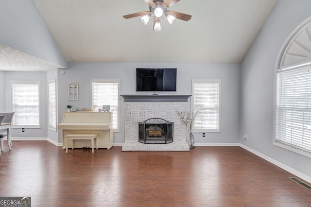 3095 Willow Park Dr, Dacula, GA 30019 - living area with wood finished floors, ceiling fan, a fireplace, lofted ceiling, and visible vents