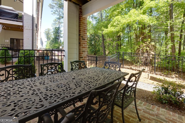 view of patio / terrace featuring outdoor dining area and fence