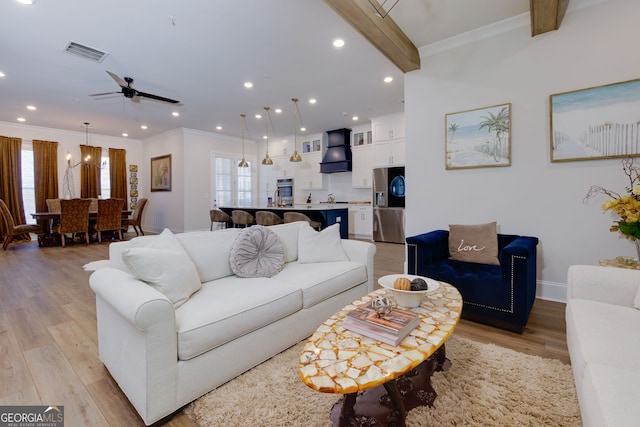living room with plenty of natural light, light wood-type flooring, crown molding, recessed lighting, and ceiling fan