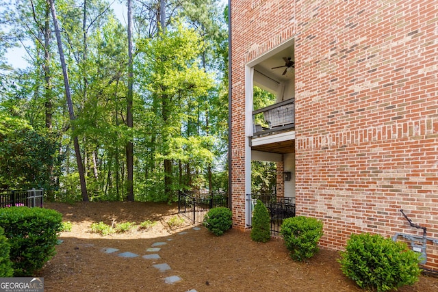 view of yard with a balcony and fence