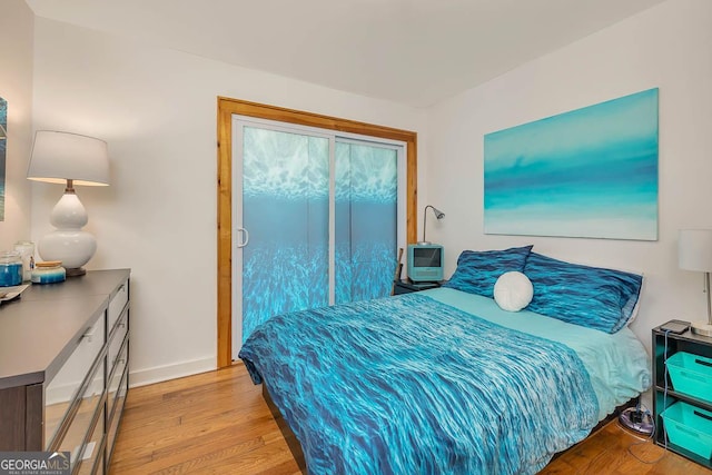bedroom featuring baseboards and light wood-style floors