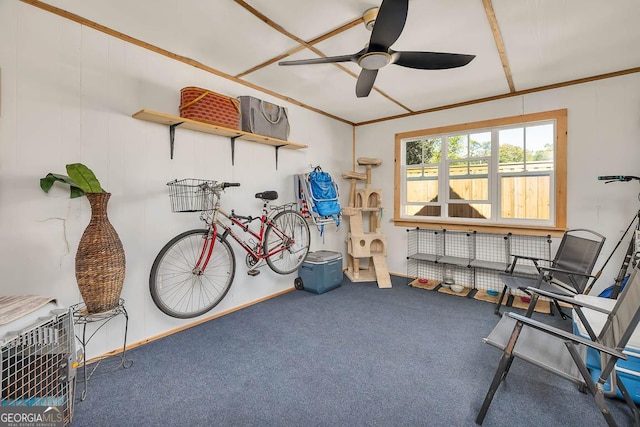 interior space featuring a ceiling fan and carpet flooring
