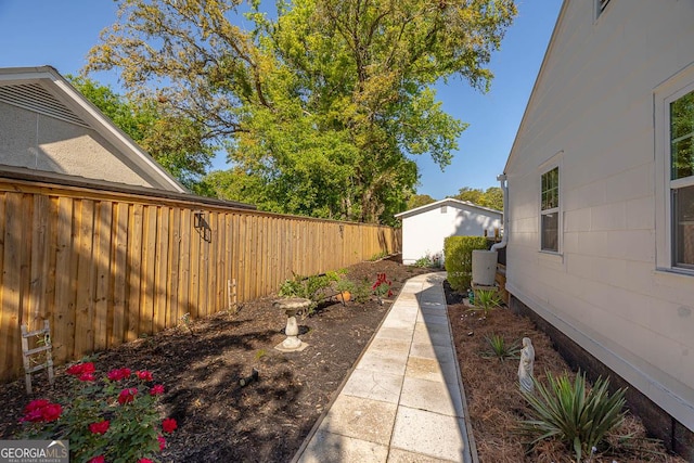 view of yard with an outdoor structure and fence