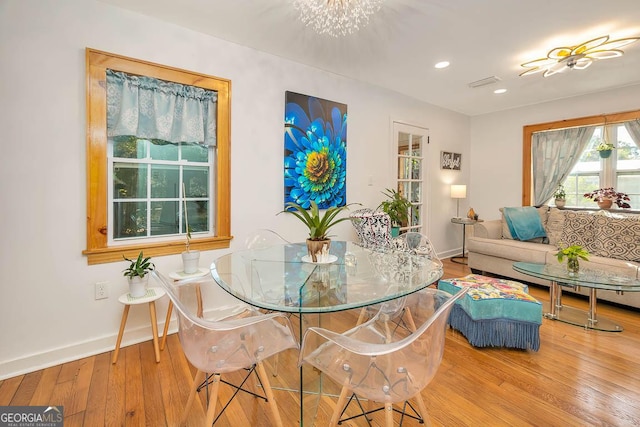 dining room with recessed lighting, hardwood / wood-style floors, visible vents, baseboards, and a chandelier