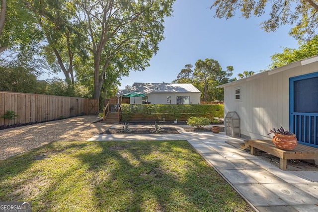view of yard featuring a patio area and a fenced backyard