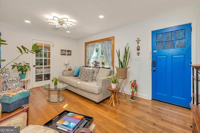 living area featuring recessed lighting, light wood-type flooring, and baseboards