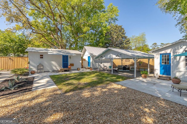 back of house with entry steps, a patio, and fence
