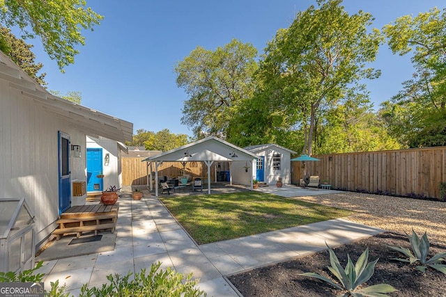 exterior space featuring a fenced backyard, an outbuilding, and a patio area