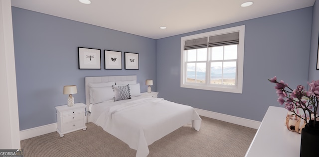 carpeted bedroom featuring recessed lighting and baseboards