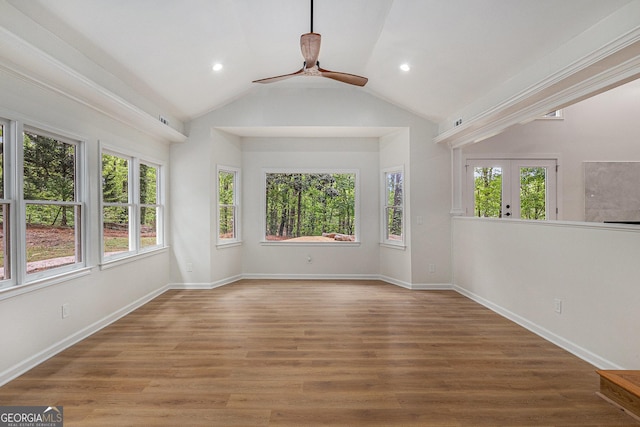 empty room with ceiling fan, a healthy amount of sunlight, and wood finished floors