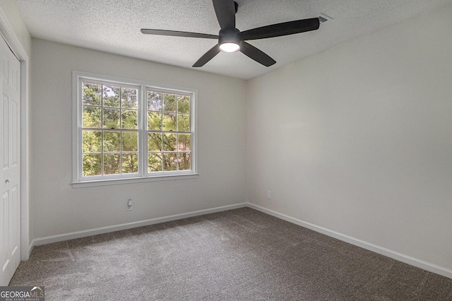 spare room with ceiling fan, carpet flooring, and plenty of natural light