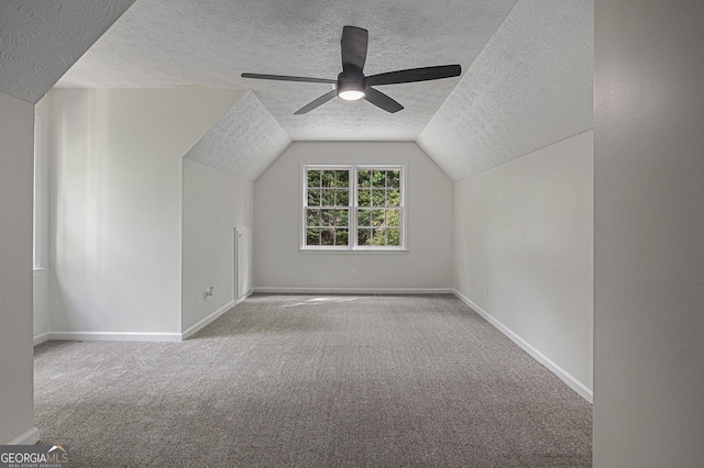 bonus room featuring carpet flooring, a textured ceiling, baseboards, and ceiling fan