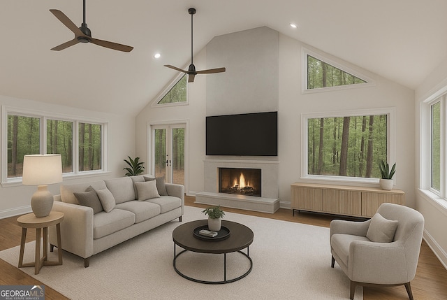 535 Emerald Pkwy, Sugar Hill, GA 30518 - living room with radiator heating unit, high vaulted ceiling, ceiling fan, a high end fireplace, and wood finished floors