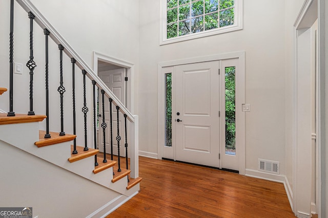 535 Emerald Pkwy, Sugar Hill, GA 30518 - entrance foyer featuring healthy amount of natural light, baseboards, wood finished floors, a high ceiling, and stairway