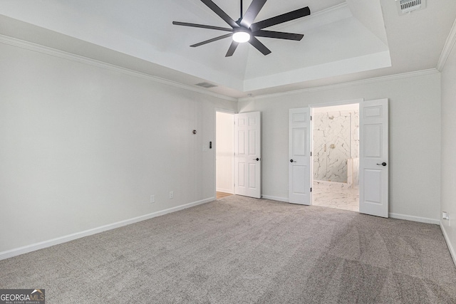 unfurnished bedroom with visible vents, baseboards, a raised ceiling, and carpet floors