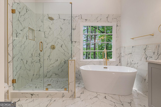 full bathroom with a marble finish shower, marble finish floor, tile walls, and a freestanding bath