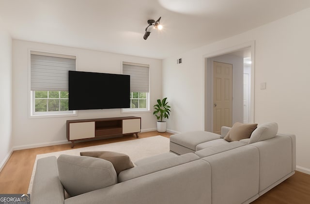 535 Emerald Pkwy, Sugar Hill, GA 30518 - living area with plenty of natural light, baseboards, and wood finished floors