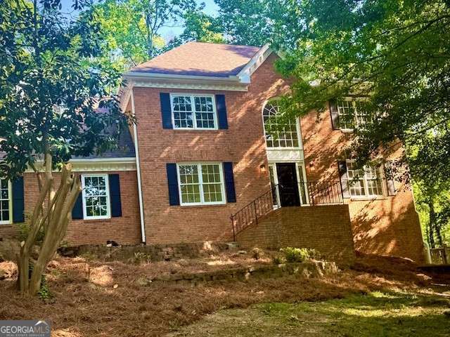 view of front of home featuring brick siding
