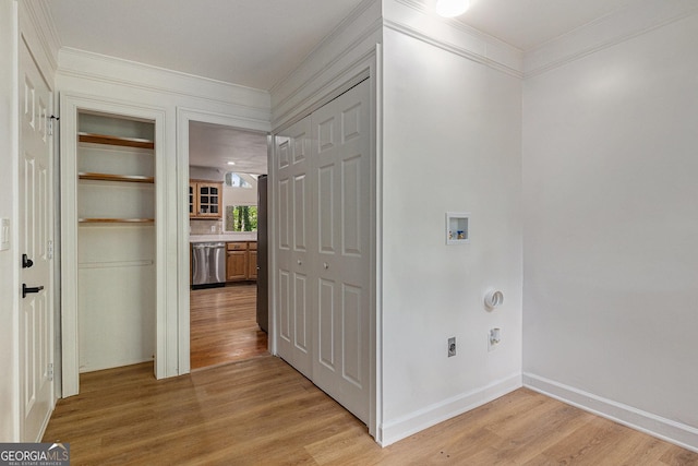 hall with crown molding, light wood-style flooring, and baseboards