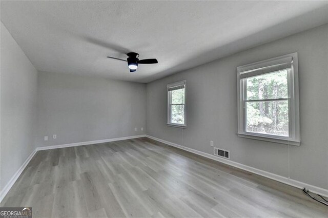 780 N Ola Rd, Mcdonough, GA 30252 - empty room featuring baseboards, a ceiling fan, wood finished floors, and visible vents