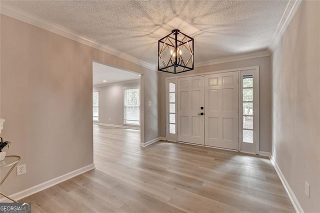 780 N Ola Rd, Mcdonough, GA 30252 - entryway with light wood-style flooring, a textured ceiling, baseboards, and an inviting chandelier