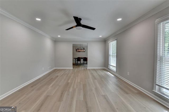 780 N Ola Rd, Mcdonough, GA 30252 - unfurnished living room with light wood-style floors, crown molding, baseboards, and ceiling fan with notable chandelier