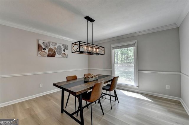 780 N Ola Rd, Mcdonough, GA 30252 - dining room featuring a notable chandelier, baseboards, crown molding, and light wood-style floors