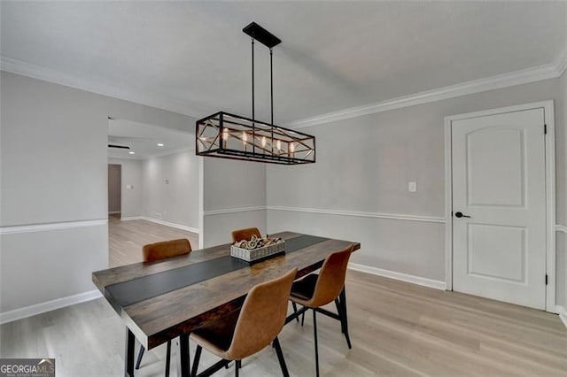 780 N Ola Rd, Mcdonough, GA 30252 - dining room featuring a notable chandelier, baseboards, crown molding, and light wood-type flooring