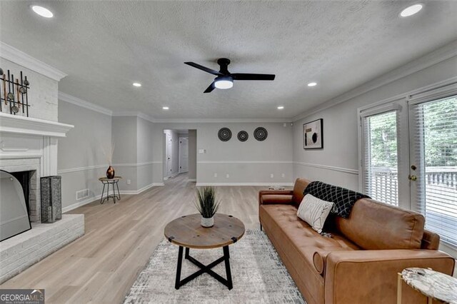 780 N Ola Rd, Mcdonough, GA 30252 - living room featuring recessed lighting, a ceiling fan, light wood-style floors, a fireplace, and a textured ceiling