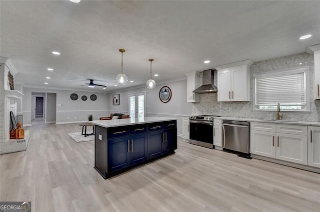 780 N Ola Rd, Mcdonough, GA 30252 - kitchen featuring wall chimney exhaust hood, stainless steel appliances, a sink, light countertops, and ornamental molding