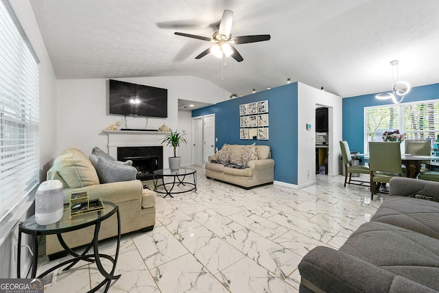 507 Lakeshore Dr, Stockbridge, GA 30281 - living room with marble finish floor, lofted ceiling, a ceiling fan, and a fireplace