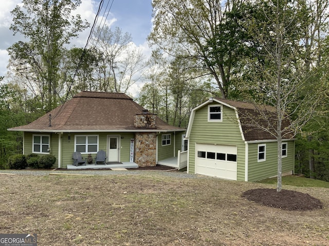426 Shenendoa Dr, Ellijay, GA 30540 - view of front facade with an outdoor structure, a detached garage, a shingled roof, and a gambrel roof