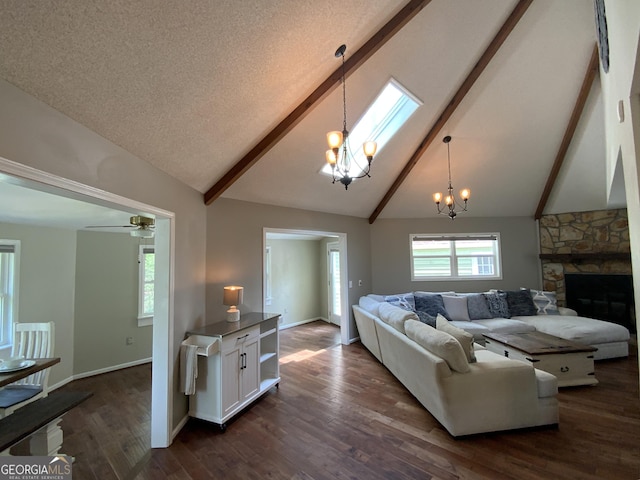 426 Shenendoa Dr, Ellijay, GA 30540 - living room with a chandelier, beam ceiling, high vaulted ceiling, dark wood-type flooring, and a stone fireplace