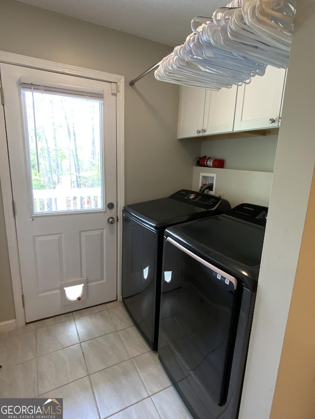 426 Shenendoa Dr, Ellijay, GA 30540 - washroom featuring cabinet space, washer and clothes dryer, and light tile patterned floors