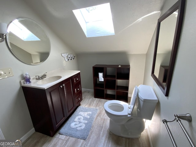 426 Shenendoa Dr, Ellijay, GA 30540 - bathroom with a skylight, vaulted ceiling, vanity, and wood finished floors